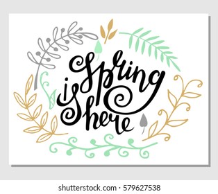 "Spring is here" hand lettering with decorative elements isolated on white background. Typographic design card.