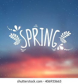 Spring is here - inscription. Vector blurred background with botanical elements.