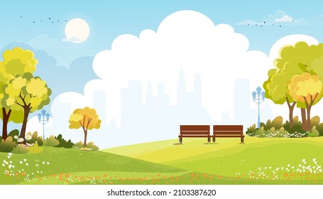 Spring landscape at city park in the morning, Natural public park with flowers blooming in the garden, Peaceful scene of green fields with blurry cityscape building, cloudy and sun on summer