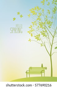 Spring landscape with tree and bench with a cat