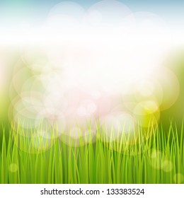 Spring natural background with grass, sky, sun glare