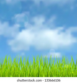 Spring natural background with the sky, clouds and grass.