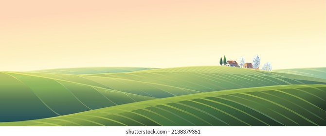 Spring rural landscape with hills and fields and village, on top of a hill.	