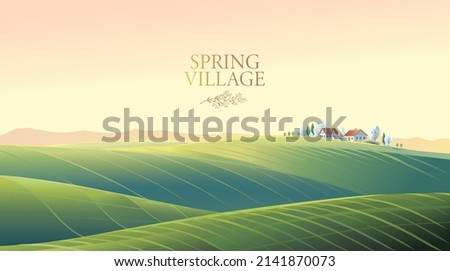 Spring rural landscape with hills and fields and village, on top of a hill.	