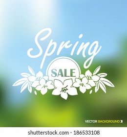 Spring sale emblem with colorful blurred background