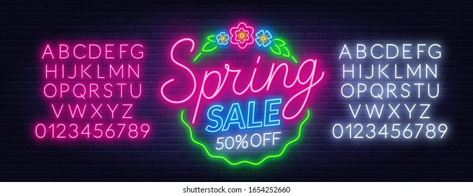 Spring sale neon sign on dark background.