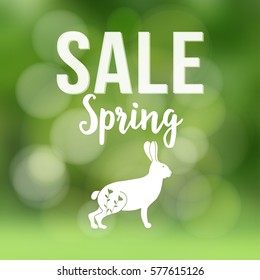 Spring sale poster with blurred background, silhouette of rabbit or hare and bokeh lights, Vector illustration.