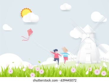 Spring season concept. Boy and girl playing kite with Windmills