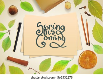 Spring template with sheets of paper and pencil. Template with green leaves and orange. Stationery mock-up with a pen and pencils on a light background.