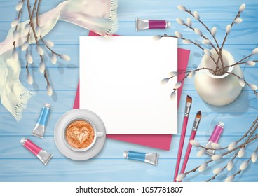 Spring top view wooden background with a cappuccino, brushes, blank sheet of paper and pussy willow branches