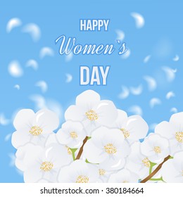 Spring white flowers the blue sky background. International Happy Women's Day concept with stylish floral decorated text 8th March. Spring flowers. 