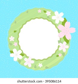 Spring wreath with cherry blossom on light blue background with copy space