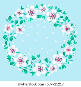 Spring wreath of white flowers. Sakura flowers in the shape of a wreath on a light blue background. Beautiful greeting card