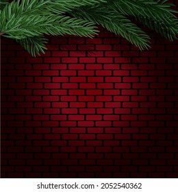 Spruce branches on the background of a red brick wall