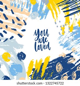 Square banner or card template with You Are Loved inspiring message and frame consisted of chaotic stains, brushstrokes, scribble, paint traces. Trendy vector illustration in modern art style.