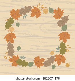 Square frame of autumn leaves and branches of various trees on a wooden surface. Autumn background design for your text, illustration for postcards and invitations.