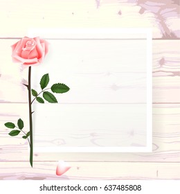 A square frame, a place for text with flowers of a pink rose, a petal on a wooden background. Can be used as a wedding invitation, birthday greeting card, engagement, thank you card. Vector 