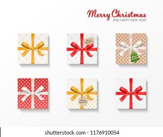 Square gift box set. Gold, red, silver color bow knot, ribbons, kraft ball and tree hang tags. Snowflake pattern paper. Merry Christmas text. Happy New Year package. Vector illustration 3d top view