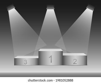 A square podium on a stage highlighted by lights