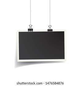 Square vector photo frame hanging on metal clips with transparent shadow. Template photo design	
