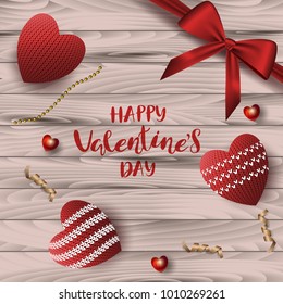 A square wooden board background with a festive inscription lettering "Happy St. Valentine's Day" with knitted red hearts. Vector. View from above.