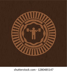 squat icon inside badge with wood background
