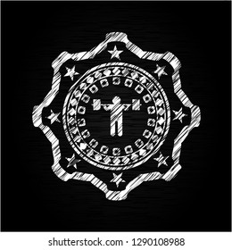 squat icon inside chalkboard emblem on black board