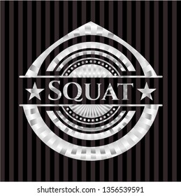 Squat silvery emblem