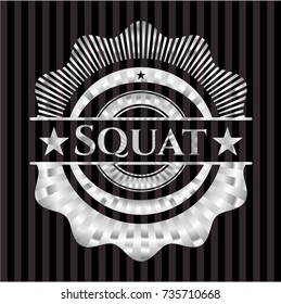 Squat silvery emblem or badge