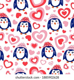 St Valentine’s Day. Seamless pattern blue baby penguins wearing pink, red and white hats. Love and romance. White background. Shape of heart. Wallpaper, textile, scrapbooking and wrapping paper