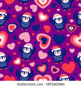 St Valentine’s Day. Seamless pattern blue baby penguins in pink, red and white hats and scarfs. Dancing with hands up. Purple background. Hearts. Wallpaper, textile, scrapbooking and wrapping paper