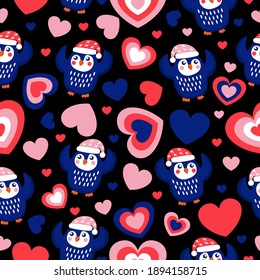 St Valentine’s Day. Seamless pattern blue baby penguins in pink, red and white hats and scarfs. Dancing with hands up. Black background. Hearts. Wallpaper, textile, scrapbooking and wrapping paper