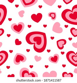 St Valentine’s Day. Seamless pattern with red and pink hearts. White background. Decorative ornament. Love and romance. Template for post cards, wallpaper, textile, scrapbooking and wrapping paper