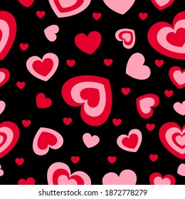 St Valentine’s Day. Seamless pattern with red and pink hearts. Black background. Decorative ornament. Love and romance. Template for post cards, wallpaper, textile, scrapbooking and wrapping paper