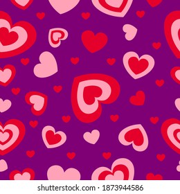 St Valentine’s Day. Seamless pattern with red and pink hearts. Purple background. Decorative ornament. Love and romance. Template for post cards, wallpaper, textile, scrapbooking and wrapping paper