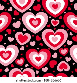 St Valentine’s Day. Seamless pattern with red and pink hearts. Black background. Decorative ornament. Love and romance. Template for post cards, wallpaper, textile, scrapbooking and wrapping paper