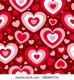 St Valentine’s Day. Seamless pattern with red and pink hearts. Maroon background. Decorative ornament. Love and romance. Template for post cards, wallpaper, textile, scrapbooking and wrapping paper