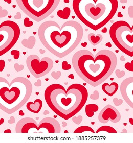 St Valentine’s Day. Seamless pattern with red and pink hearts. Pink background. Decorative ornament. Love and romance. Template for post cards, wallpaper, textile, scrapbooking and wrapping paper