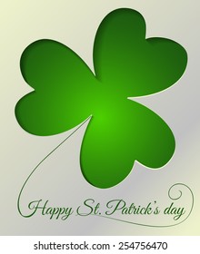  St. Patrick day card. Cut in white paper clover with three leaves and lettering on green gradient background.