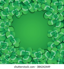 St. Patrick day card. Frame made of many three leaf clovers on green background.
