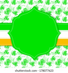 St. Patrick day card, green paper label with white stitch, irish flag ribbon and pattern with clovers on background