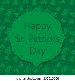St. Patrick day card. Green stitched label with lettering  on patterned background with green hand - drawn clovers. 