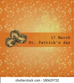  St. Patrick day card, hand- drawn three leaf clover on orange pattern with clovers background with old paper texture