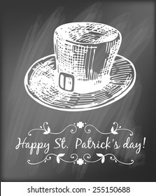  St. Patrick day card. Hand - drawn leprechaun hat and lettering in frame on chalkboard background.
