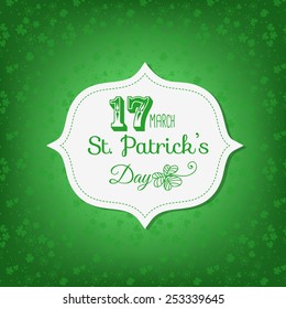  St. Patrick day card. Happy st. Patrick day lettering on white paper label with stitching on green background with clovers.