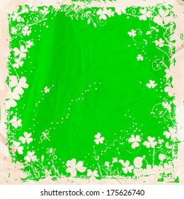 St. Patrick day card, white grunge frame with clovers and floral ornaments on green background with old crumpled paper texture