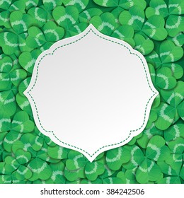 St. Patrick day card. White label with space for text on background covered with many three leaf clovers.