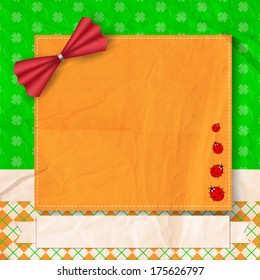 St. Patrick day card,orange card decorated with red bow and four ladybugs, white paper ribbon with space for text on patterned background with old crumpled paper texture
