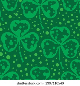 St Patrick day pattern. Seamless pattern of clover leaves and dots. Monochromatic dotted repeat pattern design. Vector drawing of clovers. Green endless background or wallpaper print.