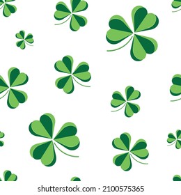 St Patrick Day. Trendy seamless pattern with three leaf clovers.  Chaotic clover pattern. Simple Repeatable design with Green clover on a White Background. Good luck symbol of ireland